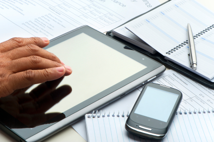 Hand typing on a digital tablet